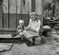 September 1942. "Richwood, West Virginia. Hazel Friend and her son, Darriell, in front of their home. The family is traveling to Batavia, New York, to work in the harvest." Photo by John Collier, Office of War Information. View full size.