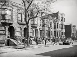 April 1941. "Old brownstone houses now occupied by Negroes in Chicago, Illinois." Medium format acetate negative by Russell Lee for the Farm Security Administration. View full size.