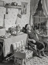 August 1941. "Mrs. Myrtle Higgins of Leraysville, New York, with some of the belongings she has packed preparing to move out of the area being taken over by the Army. Mrs. Higgins has been selling eggs and berries in the town, and her son added to her $2 a week income by working in a junkyard in Watertown. She is moving to a farm near Mexico, New York." Medium format negative by Jack Delano for the Farm Security Administration. View full size.