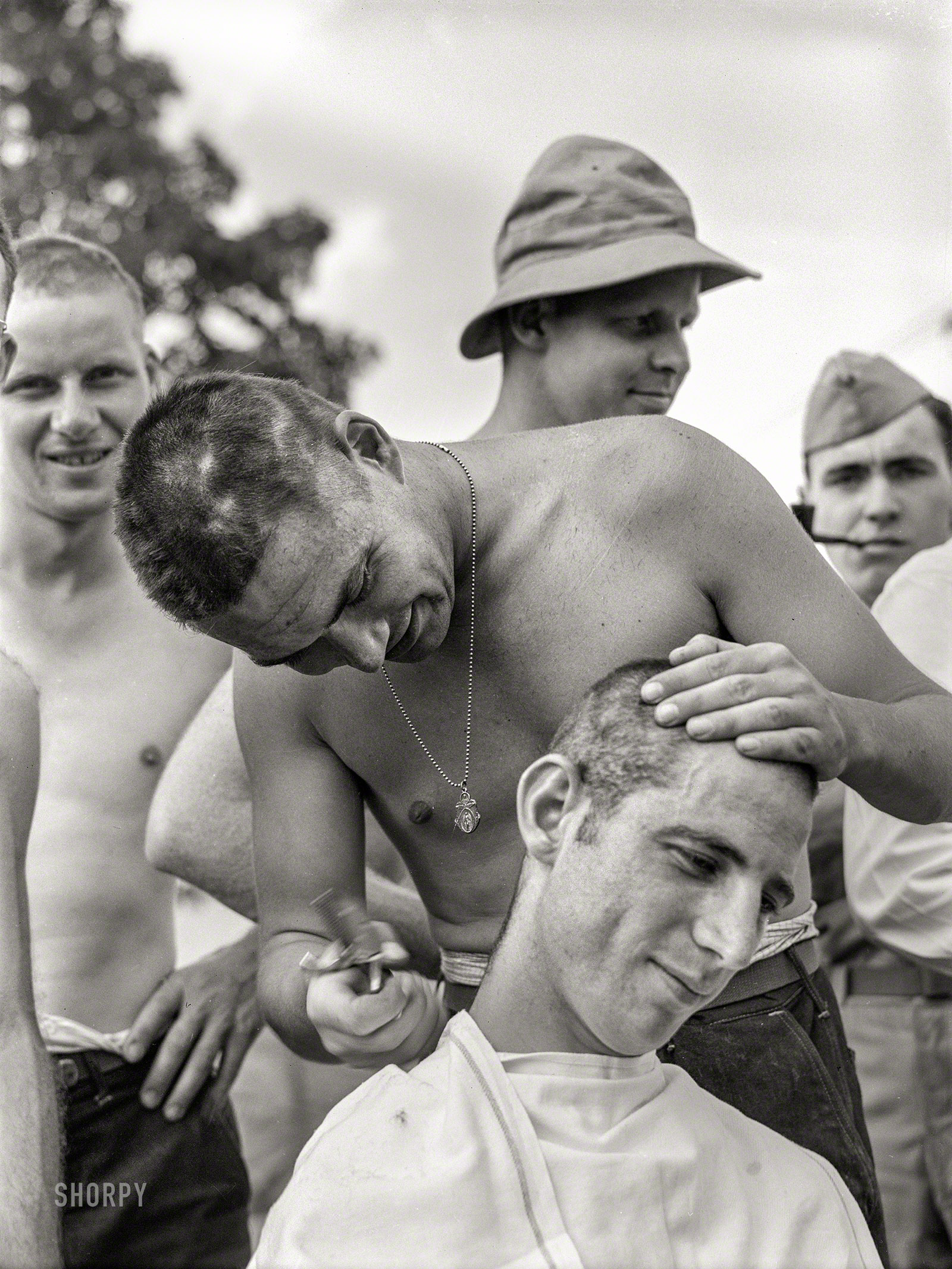June 1941. "Hattiesburg, Mississippi. Getting a haircut at Camp Shelby." The gents last seen here. Medium format acetate negative by William Perlitch. View full size.