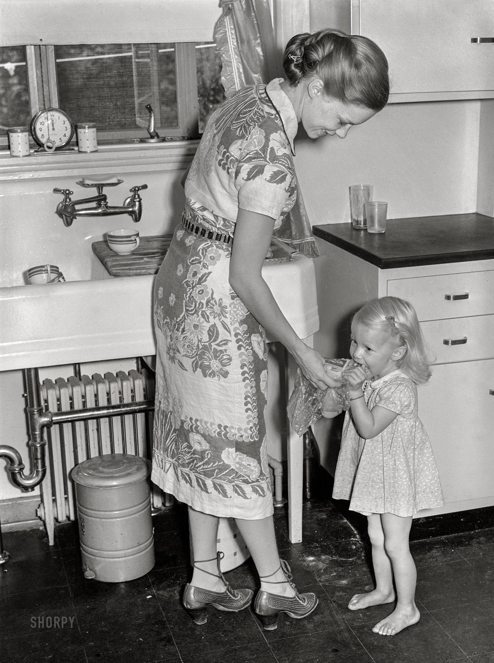 September 1938. "Mrs. Betty Zimmerman and child in kitchen of new home at Greenbelt, Maryland." Medium format acetate negative by Marion Post Wolcott. View full size.
