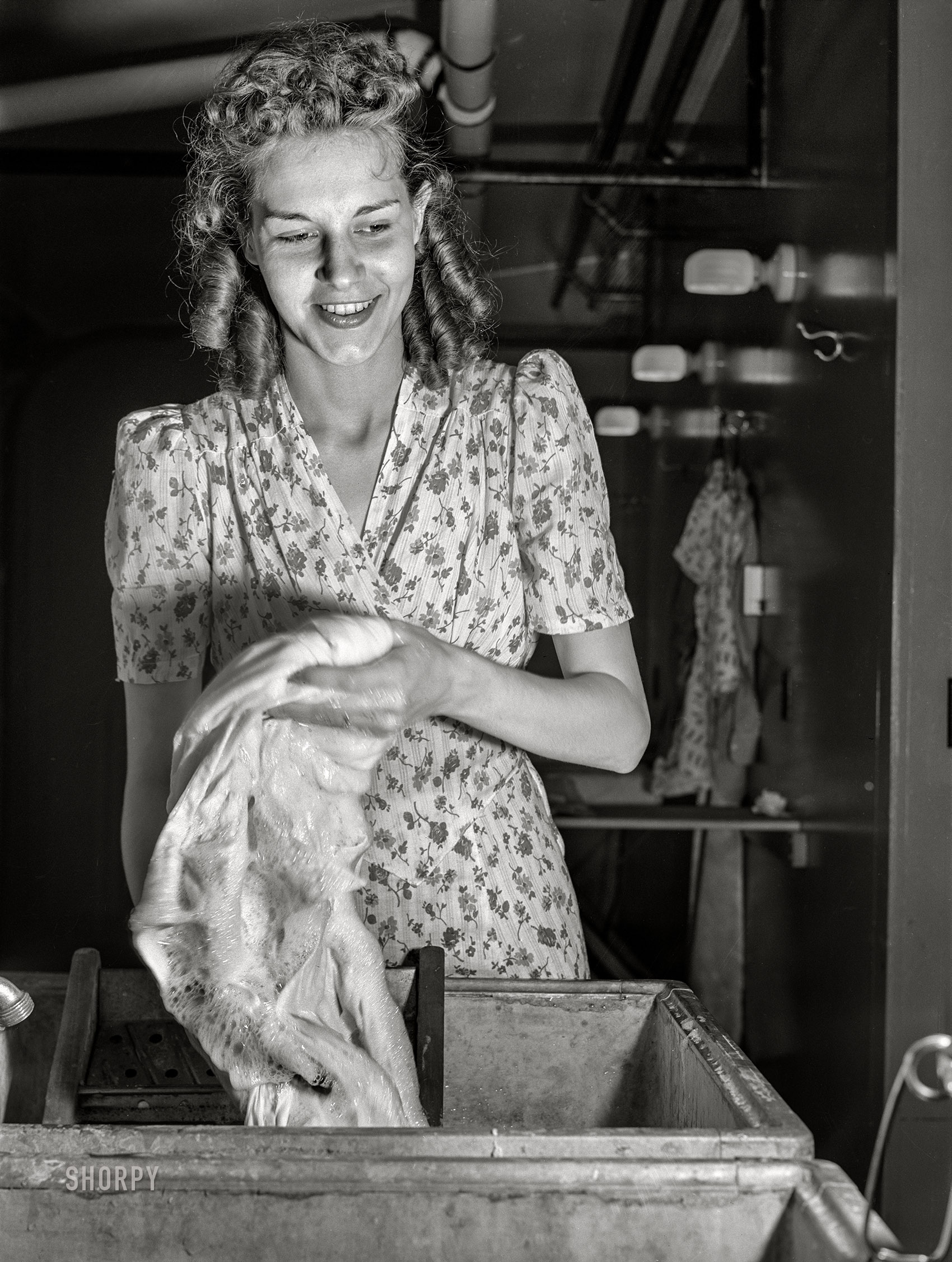 June 1941. "Wife of defense worker washing clothes in utility building at FSA trailer camp. Erie, Pennsylvania." Photo by John Vachon for the Farm Security Administration. View full size.