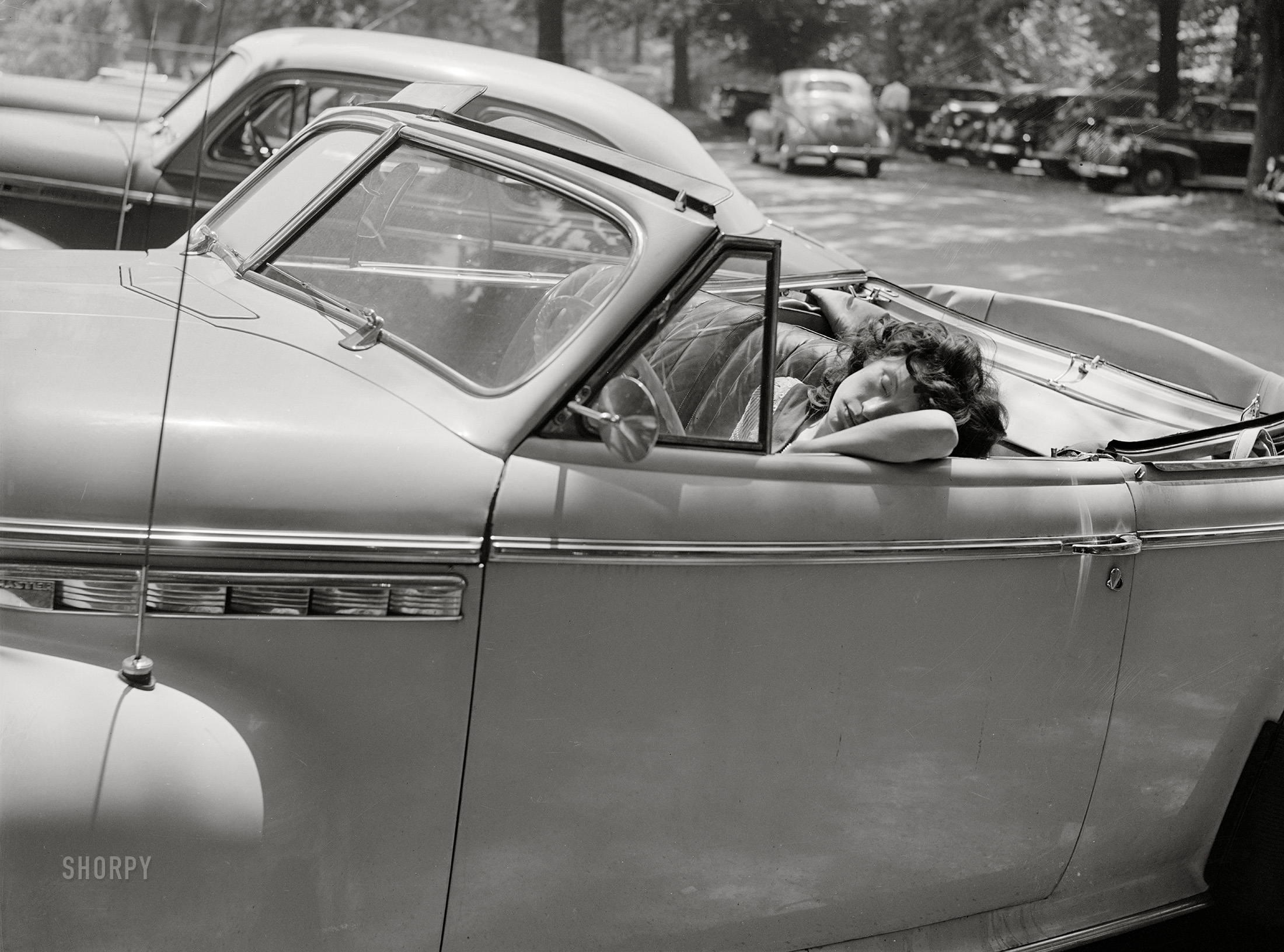 July 1942. Washington, D.C. "Sunday in Rock Creek Park. Girl sleeping in a car." Medium format acetate negative by Marjory Collins for the Office of War Information. View full size.