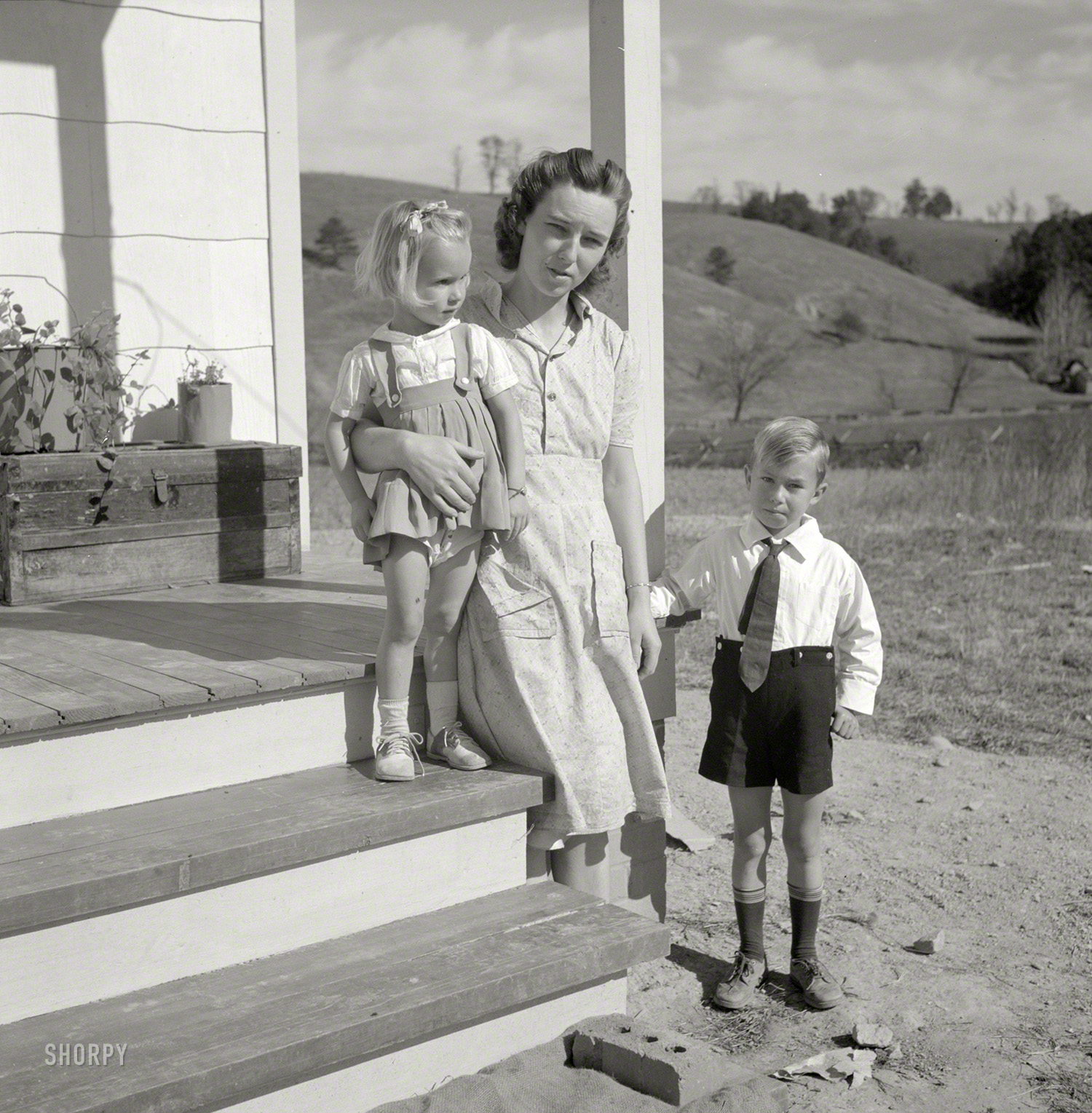 October 1941. "Radford, Virginia (vicinity). Elsie Marie and Howard Jr., children of Mr. Howard H. Smith, with their mother on the porch of their new rural home, which was built for them by the Farm Security Administration on J.T Holley's property." Photo by Marion Post Wolcott for the FSA. View full size.