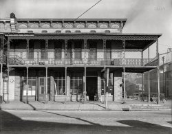 December 1935. "Main street architecture. Selma, Alabama." Premises of the Cotton Exchange and L.C. Adler & Co. furniture store. Note the fire bell tower at right. 8x10 inch nitrate negative by Walker Evans for the U.S. Resettlement Administration. View full size.