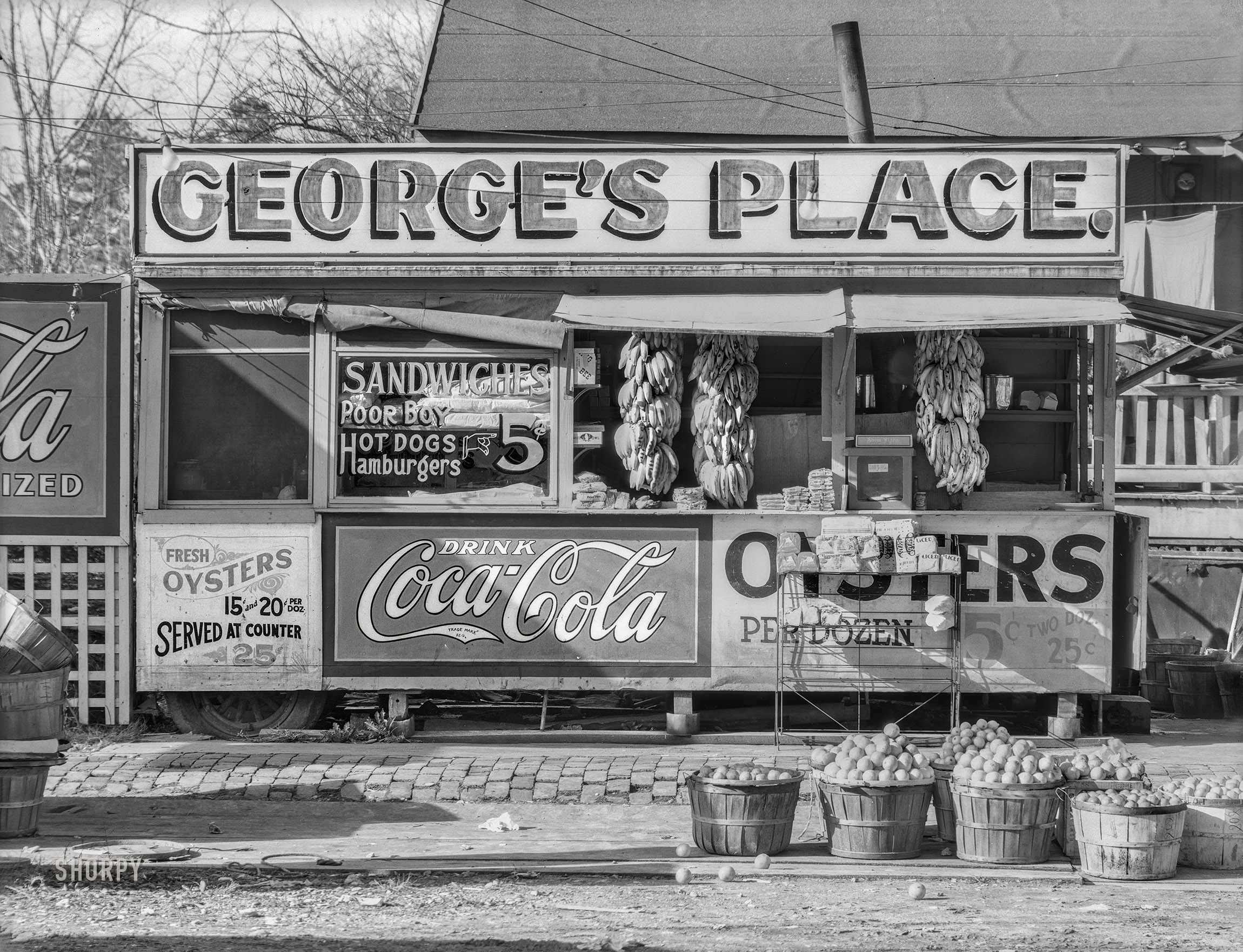 February 1936. "Roadside sandwich stand. Ponchatoula, Tangipahoa Parish, Louisiana." 8x10 inch nitrate negative by Walker Evans for the Resettlement Administration. View full size.
