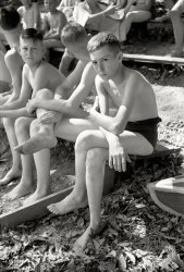 July 1942. Florence, Alabama (vicinity). "Boy Scout camp swimming class." 35mm negative by Jack Delano, Office of War Information. View full size.
The jig is up!The lad in the foreground anticipates his friends' scorn when they see that, despite his bombast on the bus, his best stroke is the dog paddle.
From the &quot;Old Days&quot;Prehistoric Speedos!
(The Gallery, Jack Delano, Swimming)
