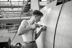 August 1942. "Nashville, Tennessee. Vultee Aircraft Company. Drilling holes for rivets in a fuselage on a sub-assembly line." In other words, doing prep work for Rosie. Photo by Jack Delano for the Office of War Information. View full size.