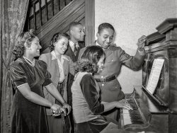 March 1942. Baltimore, Md. "Sergeant Franklin Williams, home on leave from Army duty at Fort Bragg, singing with sister Sarah, brother Thomas and best girl Ellen Hardin while his sister Annetta plays the piano." Photo by Arthur Rothstein, Office of War Information. View full size.