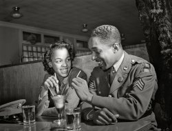 March 1942. "Baltimore, Maryland. Sergeant Franklin Williams, home on leave from Army duty, with his best girl Ellen Hardin, splitting a soda. They met at Frederick Douglass High School." Photo by Arthur Rothstein for the Office of War Information. View full size.