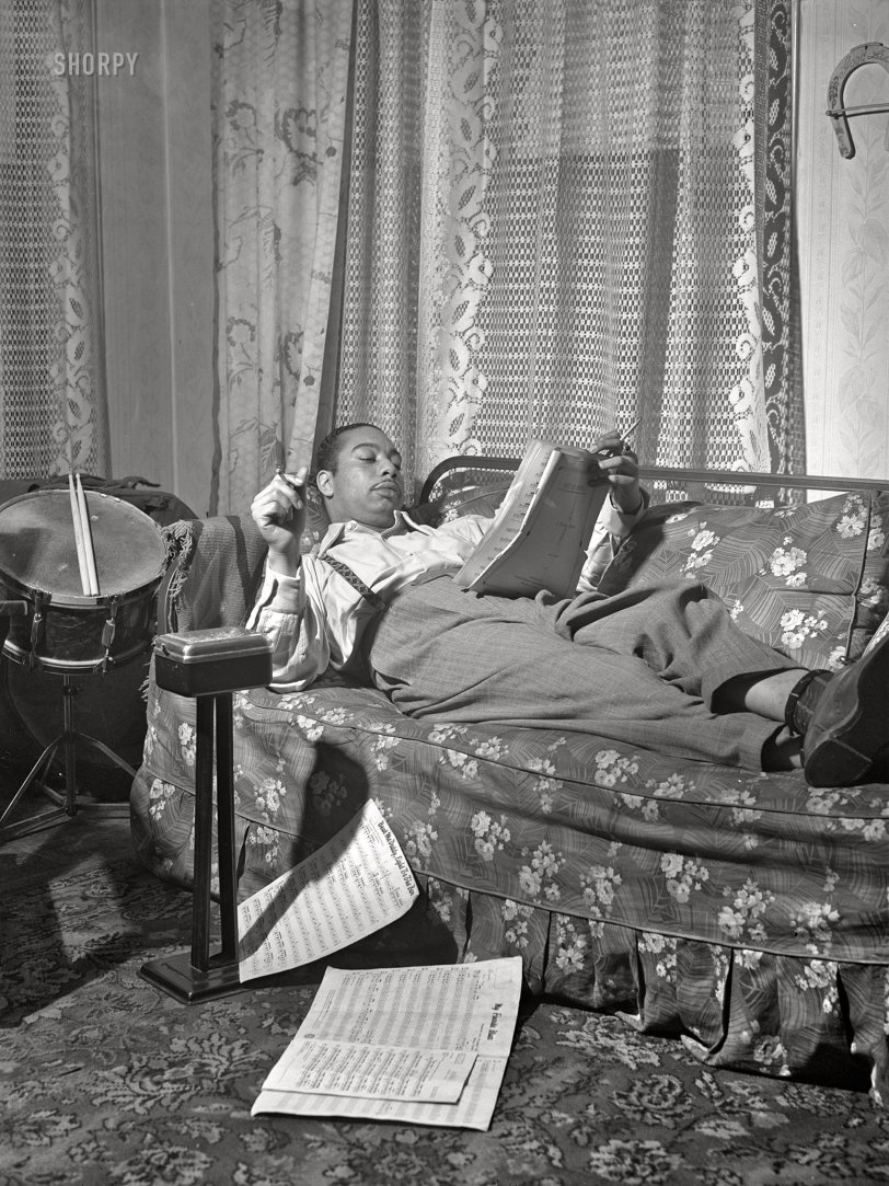 April 1942. "Mr. Oliver Coleman, drummer, looking over some music scores in the study of his apartment on Indiana Avenue. Chicago, Illinois." Acetate negative by Jack Delano for the Foreign Information Service of the U.S. Office of Coordinator of Information. View full size.
