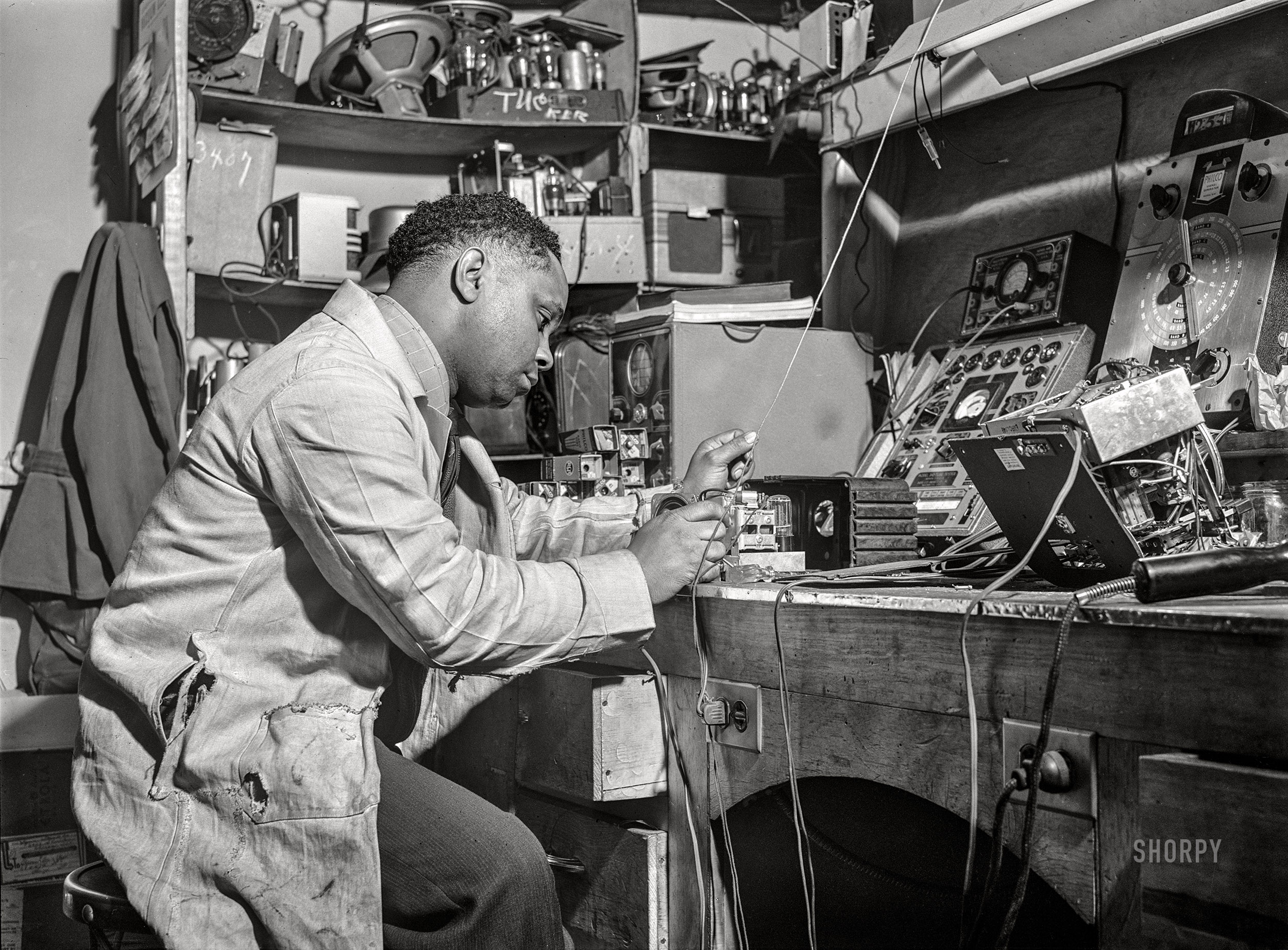 April 1942. "Chicago, Illinois -- Mr. Thomas Dorsey, radio technician, in William H. Green's radio and electrical store. Mr. Dorsey is an expert radio repairman and studied at the Tilden technical school in Chicago." Medium format acetate negative by Jack Delano. View full size.