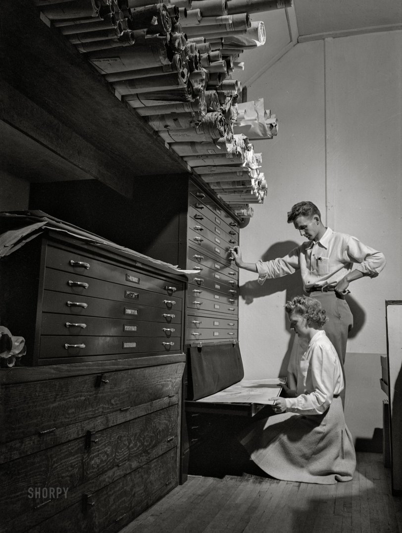 May 1942. Ames, Iowa. "Miss Mary Louise Long of Chicago and John Staley of Maryland look up drawings in the files at the landscape architecture building at Iowa State College." Acetate negative by Jack Delano for the U.S. Office of the Coordinator of Information. View full size.
