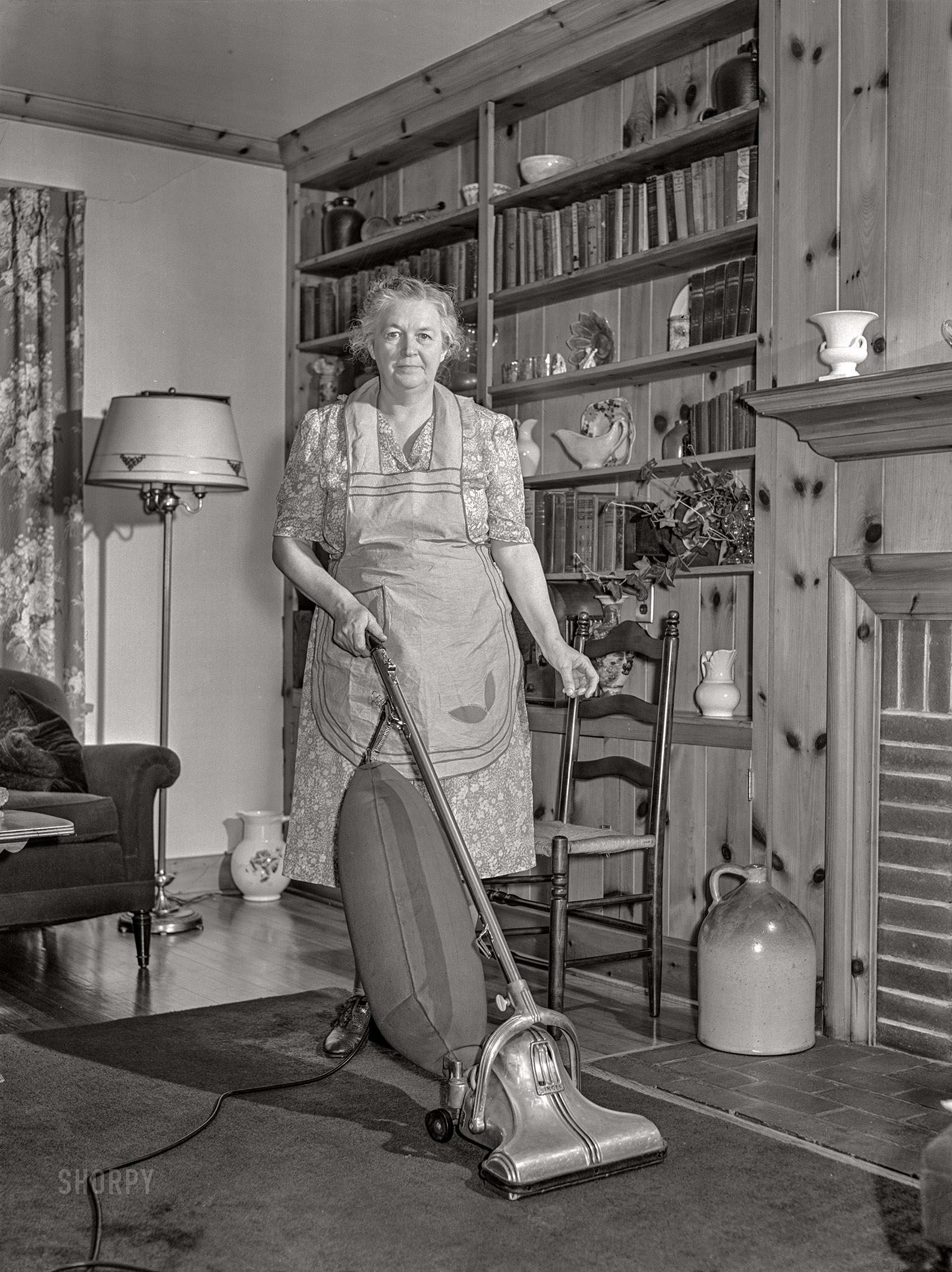 June 1942. "Knox County, Tennessee. Electrification of farms made possible by the Tennessee Valley Authority. Mrs. Wiegel, farm wife, uses electric vacuum cleaner." Acetate negative by Arthur Rothstein for the U.S. Foreign Information Service. View full size.