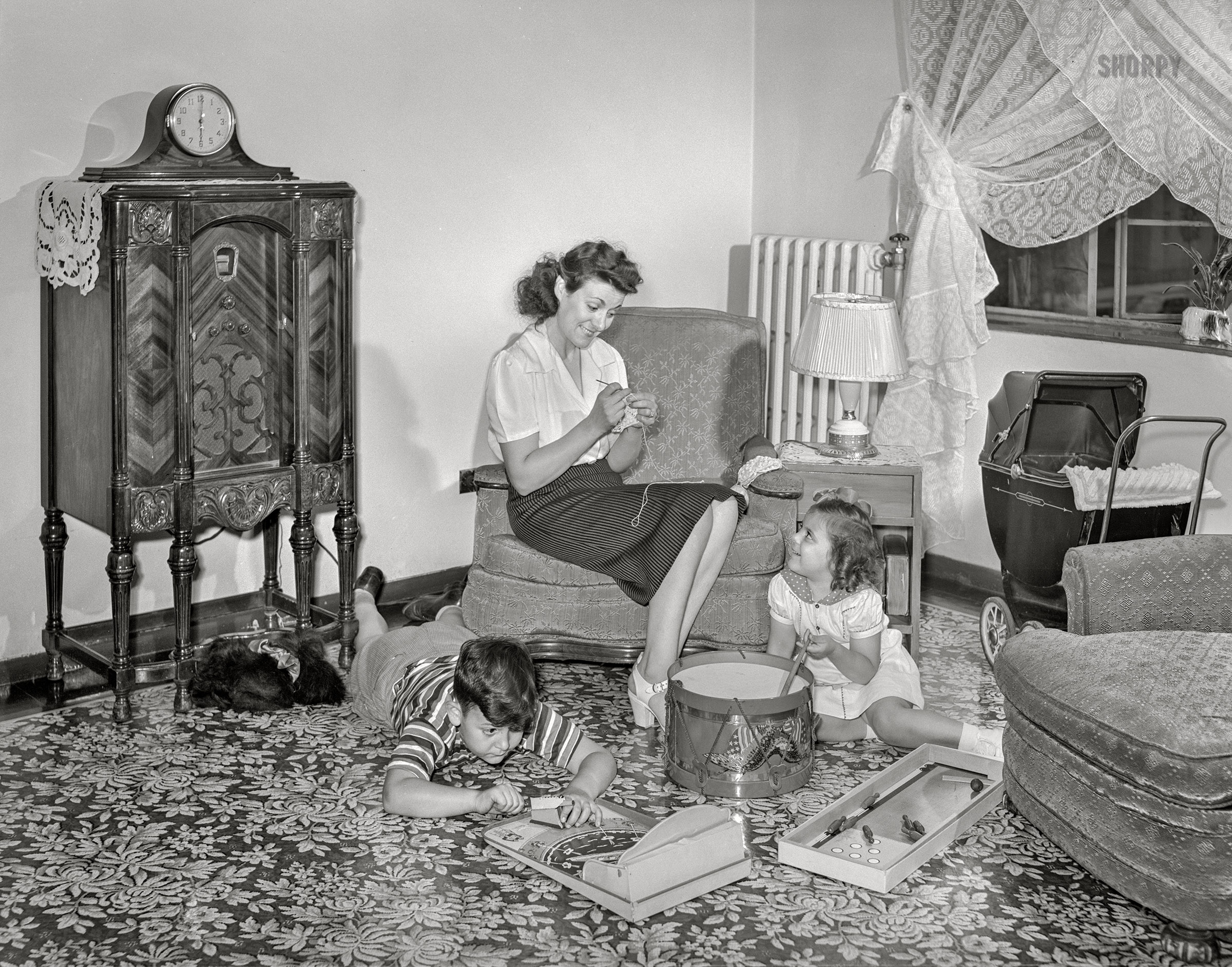 June 1942. "Brooklyn, New York. Red Hook housing development. Mrs. Caputo and her children in the living room of their four-and-a-half room apartment for which they pay $5.35 weekly." Acetate negative by Arthur Rothstein for the Office of War Information. View full size.