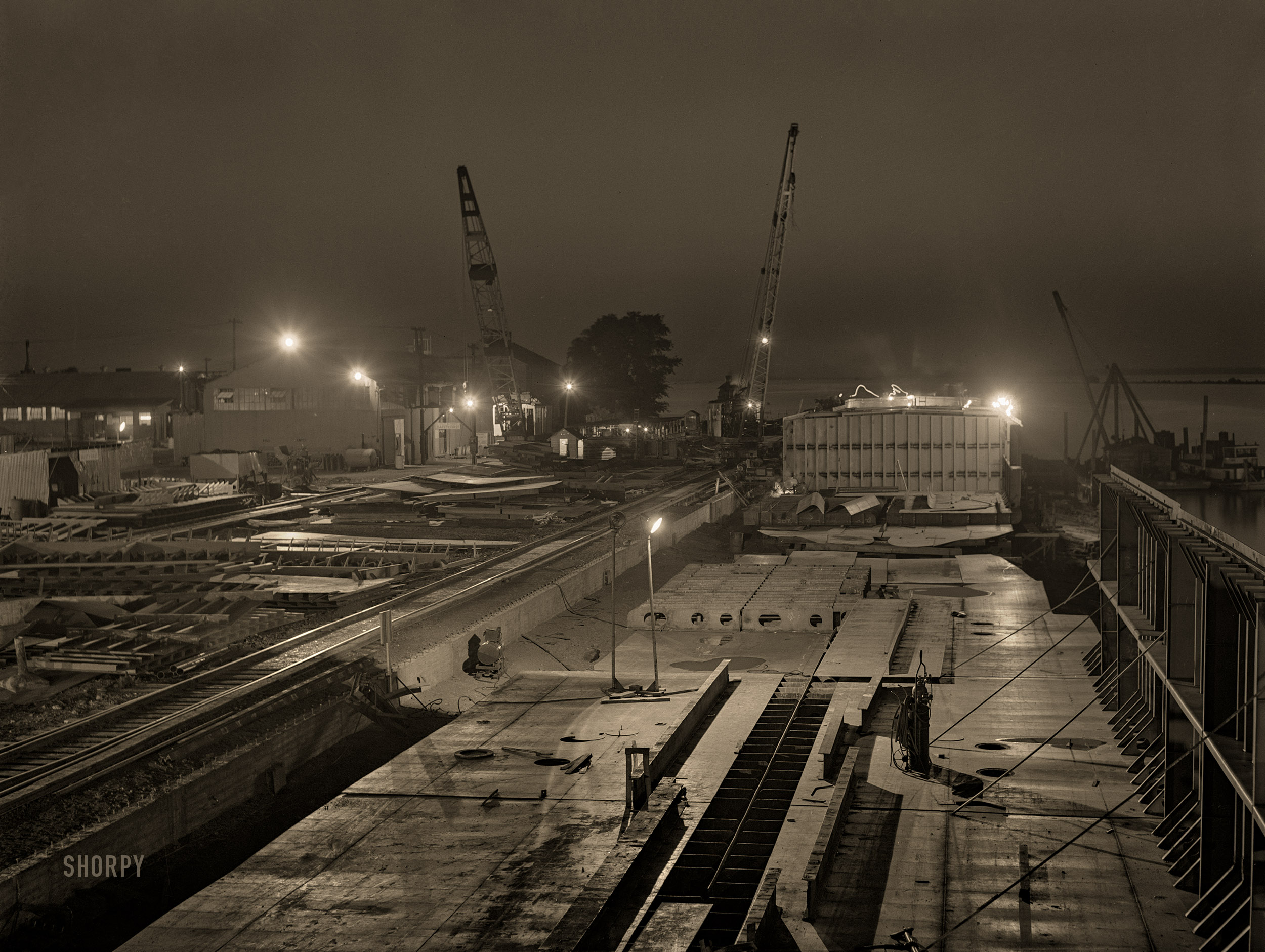 July 1942. "Decatur, Alabama. Ingalls Shipbuilding Company. Construction of ocean-going barges for the U.S. Army. Work goes on twenty-four hours a day." Medium format acetate negative by Jack Delano for the Office of War Information. View full size.