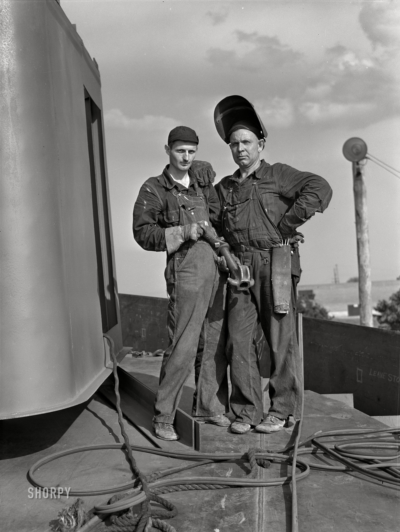 July 1942. "Decatur, Alabama. Ingalls Shipbuilding Company. Construction of ocean-going barges for the U.S. Army on the Tennessee River. A shipfitter and his helper. They are C.R. Willingham (right) and E.L. Sparkman." Acetate negative by Jack Delano. View full size.