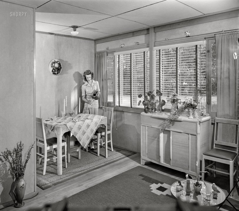 July 1942. "Middle River, Baltimore County, Maryland. Housing development for workers at the Glenn L. Martin aircraft plant. Living room and dining alcove." Porch Lady is back, pouring a nice glass of air in her Cemesto bungalow. Acetate negative by Marjory Collins. View full size.
