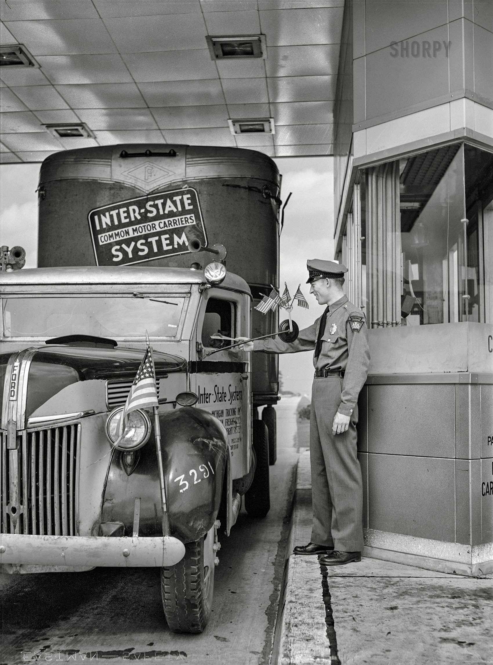 July 1942. "Pennsylvania Turnpike. Trucker paying toll." Acetate negative by Arthur Rothstein for the Office of War Information. View full size.