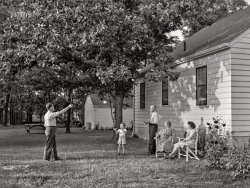 September 1942. "Cass Lake, near Pontiac, Michigan. The Westerberg family outside the home which Karl Axel Westerberg, a Swedish immigrant who is a foreman at the Dearborn plant of Ford Motor Company, and his son, Eric, built themselves after working hours.  Eric, his young son Karl, his father and mother, and Mrs. Eric Westerberg in the backyard of their house. It is a modern well-designed home with all conveniences, including an electric refrigerator and stove." Photo by Arthur Rothstein for the U.S. Foreign Information Service. View full size.