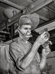 September 1942. "Detroit, Michigan. Learner at the Allison Motors plant. Dimensional finishing." Photo by Arthur Rothstein for the Office of War Information. View full size.