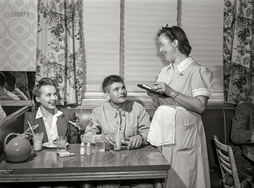 September 1942. Washington, D.C. "Sergeant George Camplair takes his girl to have some refreshments after the United Service Organization (USO) dance while he is at home on a weekend furlough." Acetate negative by Jack Delano, Office of War Information.  View full size.