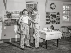 September 1942. "Fort Belvoir, Virginia. George Camplair getting his injections at the reception center." Acetate negative by Jack Delano for the Office of War Information. View full size.
Very few injections with the syringe and hypodermic needle Back in my military days mostly air injections one corpsman swabbing alcohol next one wielding the 'gun' saying don't flinch. Some flinchers results cut bloody arm guy behind them passed out. Air injection phased out due to hepatitis concerns. Those were the days my Shorpy friends.
[Commatose! - Dave]
Turn back the clockWhat a great picture !
More than 80 years ago there was a need to help Russia - How the world has changed when you look at where we are now
I really like the clock on the right of the photo - (Postal Telegraph) Years ago I bought one in California and it now hangs on the wall at my home.

Smallpox Vax?My eyesight is bad but I don't see a syringe.  Maybe making small skin punctures on his arm for smallpox?  I got mine in the 50's.  I remember a nurse tapping my arm with a small, sharp glass stylus placing the vaccine in my skin.  
That brings it all back.Jan 2, 1963 I went through the gauntlet gantlet at Ft. Leonard Wood, MO through 2 lines of "shooters".   A few needles and several pneumatic shots.  Really sore the next morning.  They told us not to flinch when they used the high pressure air guns or it would tear our skin. 
(The Gallery, Jack Delano, WW2)