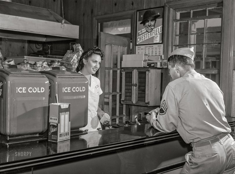 September 1942. "Fort Belvoir, Virginia. Sergeant George Camplair on one of his many visits to the post exchange." Acetate negative by Jack Delano, Office of War Information. View full size.