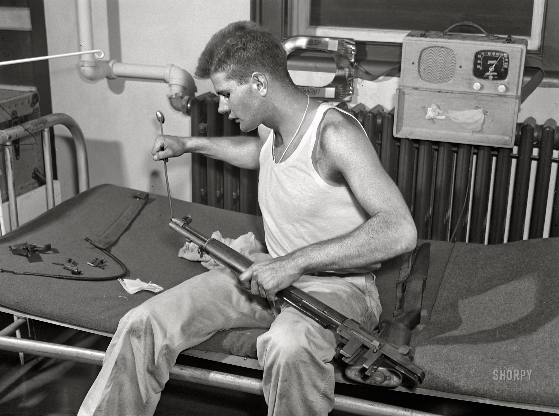 September 1942. "Fort Belvoir, Virginia. Sergeant George Camplair cleans his rifle regularly." Acetate negative by Jack Delano for the Office of War Information. View full size.