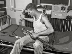 September 1942. "Fort Belvoir, Virginia. Sergeant George Camplair cleans his rifle regularly." Acetate negative by Jack Delano for the Office of War Information. View full size.
Best wishes, Sgt.Hopefully the Sgt. made it home safely and had a good, long life.  
&quot;This is my rifle,... this is my gun." The immortal scene from Stanley Kubrick's "Full Metal Jacket."
PatchesIt won't be his mom complaining about oily patches on the bed, as might have happened to this young man  https://www.shorpy.com/node/24096.
Seems he has the warmest spot during winter months.
What&#039;s taped to the inside of the drop-down radio lid?(And I'm sure someone out there knows what station it's tuned to.)
[It's a girl! Hugging a pillow! - Dave]
The Zenithappears to be tuned to 1090 kilocycles, WBAL in Baltimore, which at 50kw power would have come in well in greater Washington.
Nice &amp; ToastyI'll bet that's a warm bed to sleep in with that radiator right there.
What is the purposeOf the large magnet, also sitting on the radiator?  I hope the answer has something to do with attracting attractive women.
J W Wright, thanks for the answer and the link.  So, the Zenith Radio Wavemagnet is today what we call an antenna?  I wasn't even for sure it was attached to the radio.
Zenith &quot;Wavemagnet&quot;Click image for more information than you wanted:
 

Aught-SixLooks like a WW1 surplus 30.06 rifle?
Chutist Looks Vaguely FamiliarEschewing his sleigh, Santa parachuted into Vietnam so as not to grab unwanted attention. Sgt Camplair's radio attachment is, however, somewhat familiar.
M1 GarandThe rifle is an M1 Garand, in 30.06, semiauto, fed by a 8 round clip.
The fact that these new front line rifles were being issued stateside as early as 1942, rather than being reserved solely for the overseas theaters, shows the power of US industry.
M1 GarandFor missing link - that is not a WWI surplus rifle.  It is an M1 Garand.  It is in .30-06.  I've cleaned many of them.
M1 Garand RifleThe rifle is actually an M1 Garand semi-automatic. Shoots 30/06 ammo out of 8 round clips. 
M1 IDIt is an M1 Garand. An unmistakable profile. The M1 replaced the bolt-action M1903 Springfield as the U.S. service rifle in 1936 and was itself replaced by the selective-fire M14 rifle on March 26, 1958.
ShinyIt appears that the dark finish of the gas cylinder on Sergeant Camplair's M1 has worn off, exposing the stainless steel (can't tell for sure though). If so, it's odd that it would wear off so early in the conflict. Shiny bits on oneself is not a good thing in combat.
He'd also better be careful in cleaning the bore so as not to damage the muzzle, as he might at the angle shown.  The cleaning rod has to be in direct line with the bore.
On a side note, it's great to see that fellow Shorpyites own M1s as well.  Now if M2 ball ammo was readily available again...
WW2 M1It has all the earmarks of a WW2 M1 Garand. I remember stripping them down followed by the reassembly process from ROTC training in 1963. It is definitely an M1 receiver by his left knee on the edge of the bunk.
DownrangeU.S. ‘Rifle, .30 Caliber, M1’ AKA: M1 Garand, a .30-06 caliber, gas operated, magazine fed, semiautomatic rifle once described by General George S. Patton as "the greatest battle implement ever devised”.
When the USA entered World War 2, mass production of the M1 rifle began at the Springfield armory and at the Winchester plant. During the war, both companies produced between them approximately 4 million M1 rifles, making them the most widely used semi-automatic rifle of World War 2.
M1 Garand "stripping" for cleaning and inspection here.
M-1 Garand semiautomatic shoulder weaponGen Patton called it the greatest combat weapon ever invented. 
I have one I bought from the CMP.
Ping!
(The Gallery, Jack Delano, WW2)