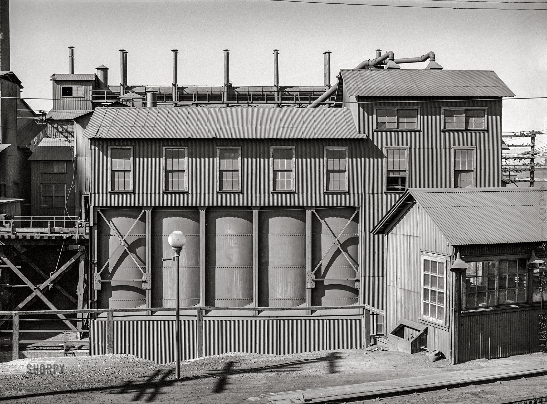 September 1942. Deer Lodge County, Montana. "Smelter of the Anaconda Copper Mining Company. Reverberatory furnace buildings." Acetate negative by Russell Lee. View full size.
