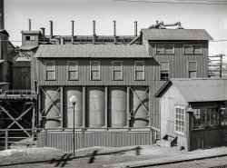 September 1942. Deer Lodge County, Montana. "Smelter of the Anaconda Copper Mining Company. Reverberatory furnace buildings." Acetate negative by Russell Lee. View full size.
Or maybe ..Copper hoppers?
What what what a Word word wordAs a musician I am always aware of the acoustics in any given room, but I'm scratching my head about what the word 'reverberatory' has to do with a copper furnace.
[If only there was an easy way to look up unfamiliar terms ?!? - Dave]
Not just for Charles Sheeler fansDoes anyone else find this beautiful?
(The Gallery, Industry & Public Works, Mining, Russell Lee)