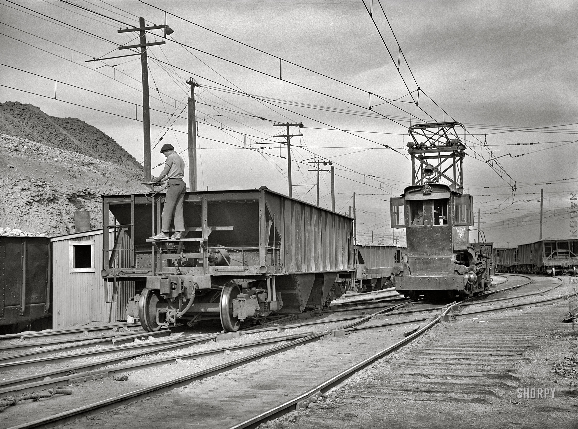 September 1942. Deer Lodge County, Montana. "Anaconda smelter, Anaconda Copper Mining Company. Individual ore cars are pushed to the ore dump by an electric locomotive." Acetate negative by Russell Lee for the Office of War Information. View full size.