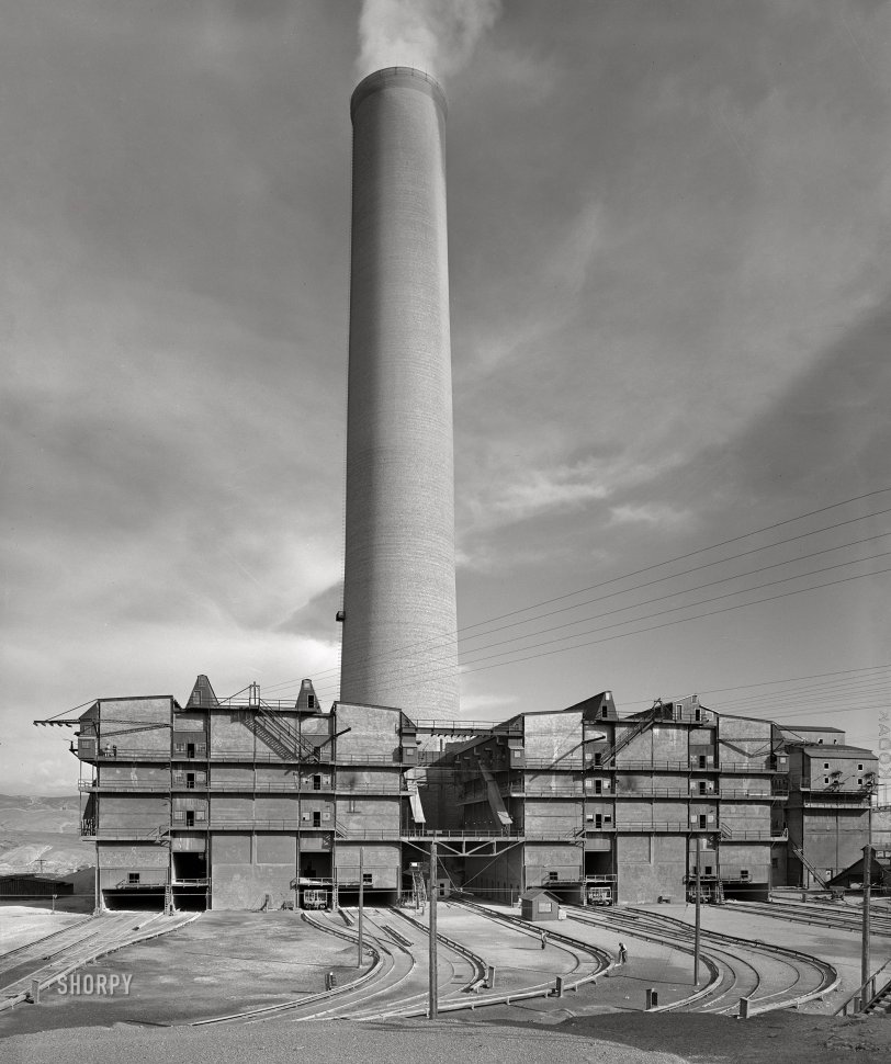 September 1942. Deer Lodge County, Montana. "Anaconda Smelter of the Anaconda Copper Mining Co. The smokestack is the largest in the world: 585 feet in height with a diameter at base of seventy-five feet and at top of sixty feet. Flue gases are discharged at the rate of three to four million cubic feet per minute. The arsenic plant and flue gas cleaning apparatus are seen at the base of the stack." Photo by Russell Lee, Office of War Information. View full size.
