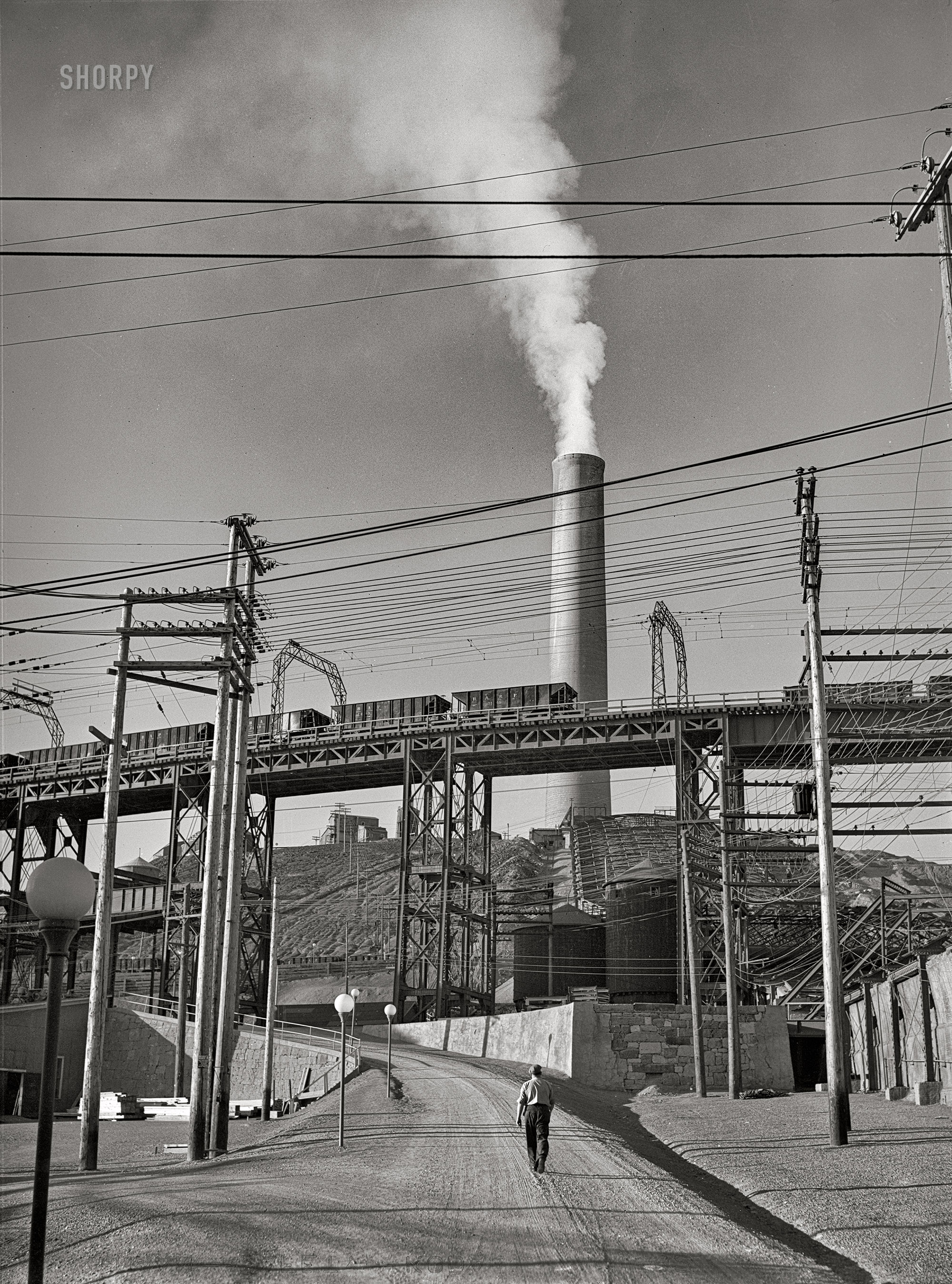 September 1942. Deer Lodge County, Montana. "Anaconda smelter. Ore cars and smokestack." Acetate negative by Russell Lee for the Office of War Information. View full size.