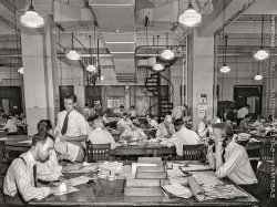 September 3, 1942. "New York, New York. Newsroom of the New York Times newspaper. Right foreground, city editor. Two assistants, left foreground. City copy desk in middle ground, with foreign desk, to right; telegraph desk to left. Makeup desk in center back with spiral staircase leading to composing room. Copy readers go up there to check proofs." Medium format acetate negative by Marjory Collins for the Office of War Information. View full size.