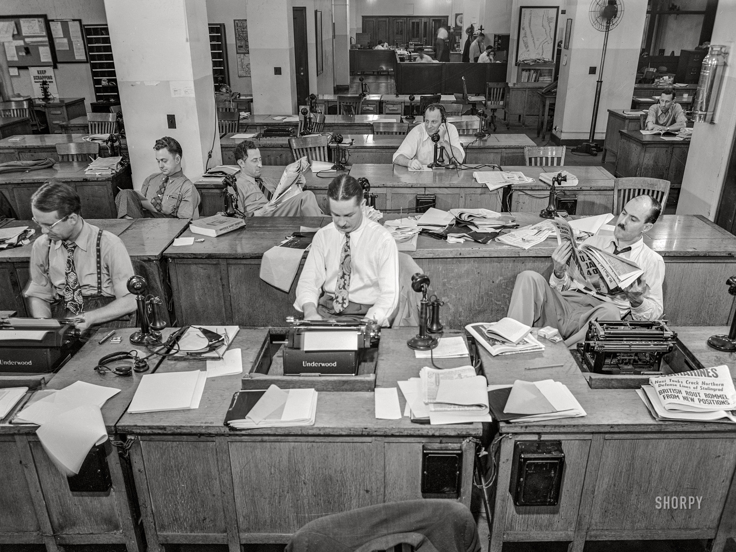 September 3, 1942. "New York, New York.  Newsroom of the New York Times newspaper. Reporters and rewrite men writing stories, and waiting to be sent out. Rewrite man in background gets the story on the phone from reporter outside." Medium format acetate negative by Marjory Collins for the Office of War Information. View full size.