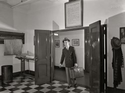 September 1942. "New York, New York. Photographic department of the New York Times newspaper. One of eight staff photographers returns to staff room after assignment. Over door is eulogy of news camera. At left are maps of the city and region for photographers' reference." Acetate negative by Marjory Collins for the Office of War Information. View full size.