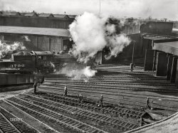 November 1942. "Chicago, Illinois. Maintenance crew repairing roundhouse tracks at an Illinois Central Railroad yard." Photo by Jack Delano, Office of War Information. View full size.