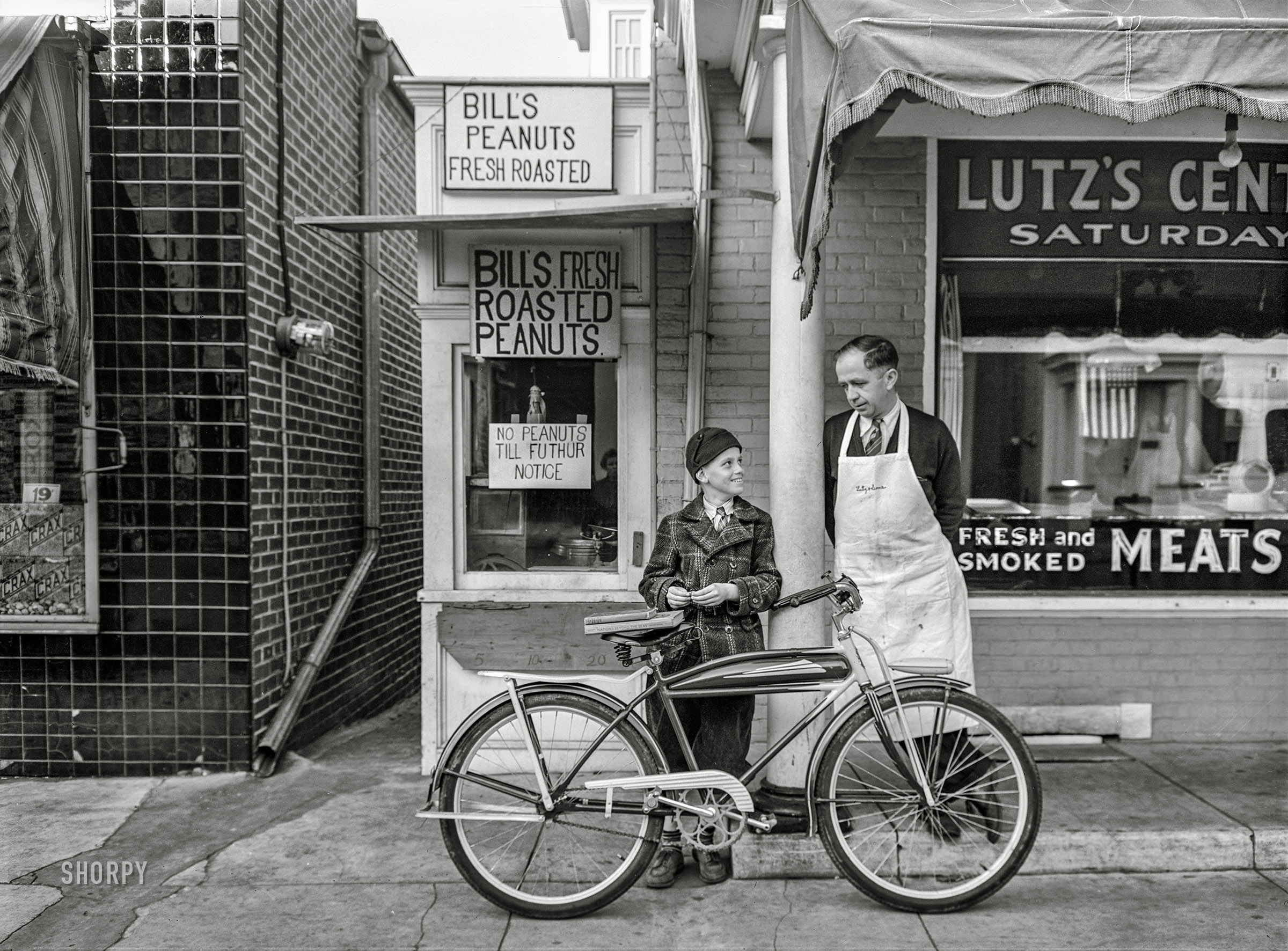 November 1942. Lititz, Pennsylvania. "Small town in wartime. Peanut stand next to the Lutz butcher shop finds it hard to get peanuts since the war started. Peanut oil is needed in industry." Acetate negative by Marjory Collins for the Office of War Information. View full size.