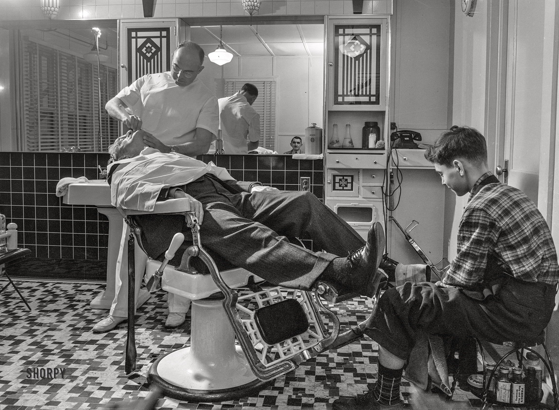 November 1942. "Lititz, Pennsylvania. Wartime activities of a small town. Mr. Pennepacker, one of seven barbers in town, has sixty less haircuts a month since the boys left town." Acetate negative by Marjory Collins for the Office of War Information. View full size.