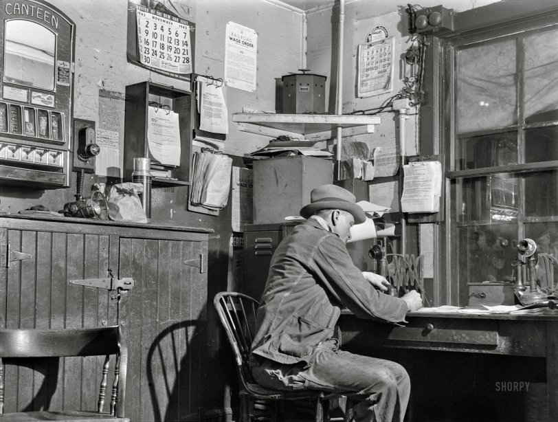 December 1942. "Chicago, Illinois. Train clerk working on his lists in the hump office at a Chicago and North Western railyard." Acetate negative by Jack Delano. View full size.