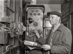 December 1942. "Chicago, Illinois. Hump master in a Chicago and North Western Railroad yard operating a signal switch system which extends the length of the hump track. He is thus able to control movements of locomotives pushing the train over the hump from his post at the hump office." Acetate negative by Jack Delano for the Office of War Information. View full size.