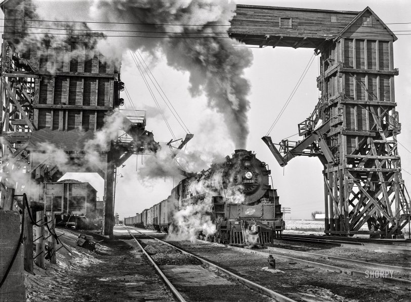 January 1943. "Nelson, Illinois. Chicago and North Western Railroad freight en route from Clinton, Iowa, to Chicago. Stopping for coal and water to give passenger trains the right of way." Acetate negative by Jack Delano for the Office of War Information. View full size.