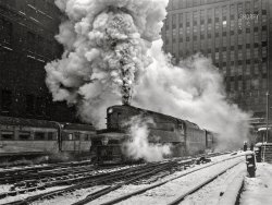 February 1943. "Chicago, Illinois. One of the Pennsylvania Railroad's giant '6100' class [T1 prototype] engines pulling out of Union Station on the 'Manhattan Limited' run." Medium format acetate negative by Jack Delano for the Office of War Information. View full size.