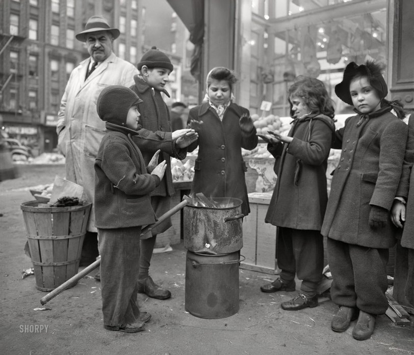 February 1943. "New York, New York. Italian-American children warming their hands by fruit stand outside a grocery store at First Avenue and Tenth Street." Medium format acetate negative by Marjory Collins for the Office of War Information. View full size.