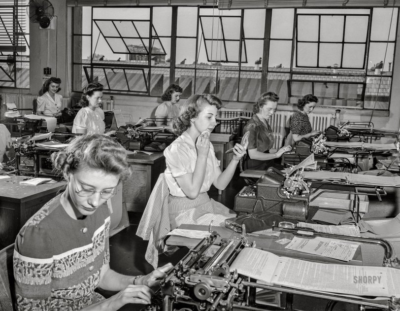 May 13, 1942. "Detroit, Michigan. Style show presented by Chrysler Girls' Club at Saks Fifth Avenue store and scenes at plant. Chrysler Corporation office workers (one powdering her chin) typing various forms." Photo by Arthur Siegel for the Office of War Information. View full size.