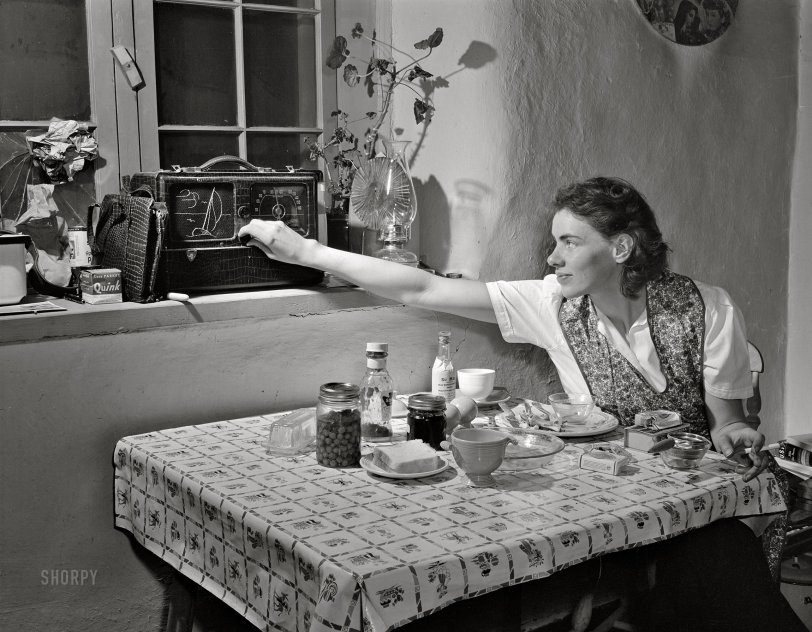 January 1943. Penasco, New Mexico. "Marjorie Muller, Red Cross nurse at the clinic operated by the Taos County cooperative health association. The radio is her only contact with the outside world. Papers come rarely to the town, and she must depend on news broadcasts to follow daily events." Acetate negative by John Collier,  Office of War Information. View full size.