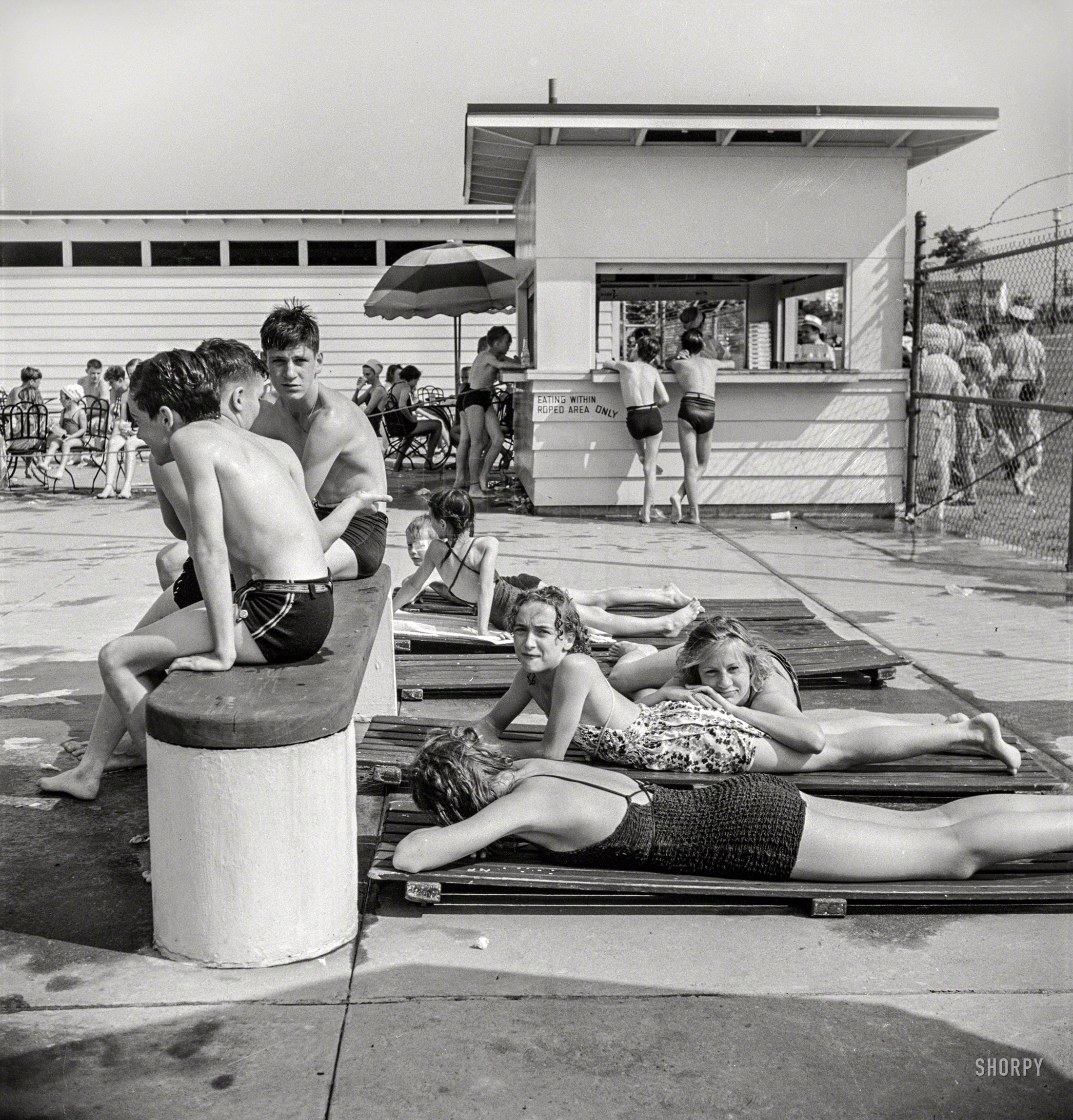 June 1942. Greenbelt, Maryland. "Sunbathers at the swimming pool." Medium format negative by Marjory Collins, Office of War Information. View full size.