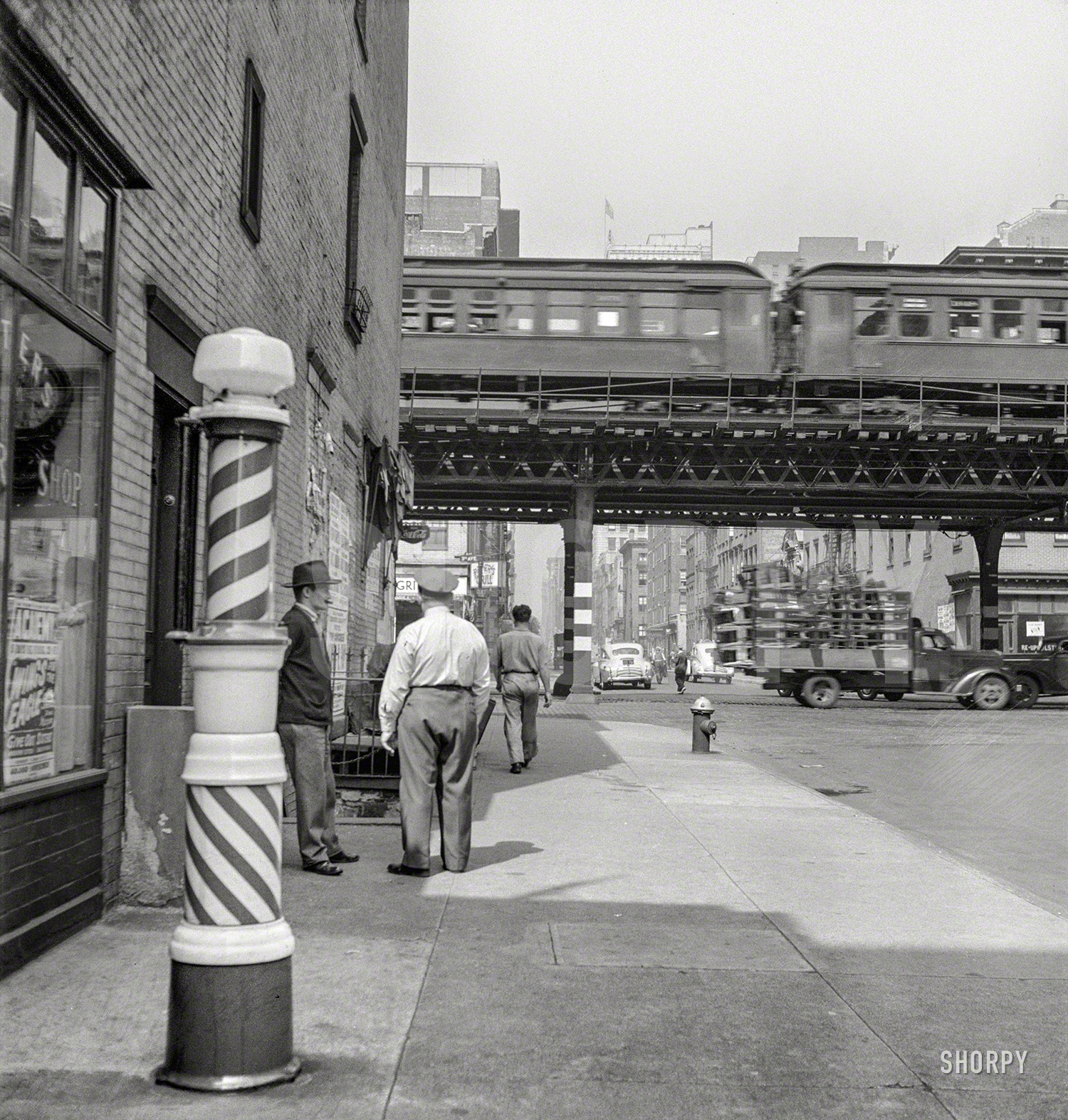 September 1942. "New York, New York. Looking west from the 17th Street station at the Third Avenue elevated railway as a train leaves on the local track." Photo by Marjory Collins for the Office of War Information. View full size.